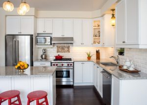 Professional gas range and range hood, white cabinet, antique ceiling lamps, fine bone china teacups in cabinets. Chalk paint hand-painted stools. Antique brass fruit tray. Antique cherry wood tea tray.