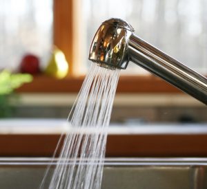 kitchen sink faucet with water running