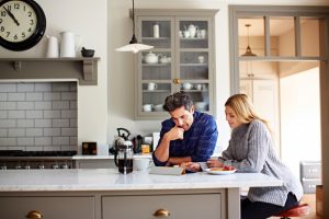 young-couple-looking-at-tablet-in-kitchen