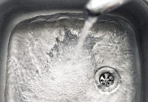 tap-water-flowing-down-drain