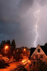 neighborhood-under-dark-sky-with-lightning