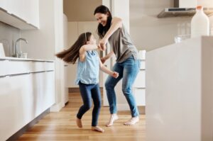 woman-and-child-dancing-on-wood-floor