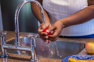kitchen-sink-woman-washing-fruit