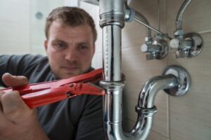 sink-drainpipe-plumber-at-work